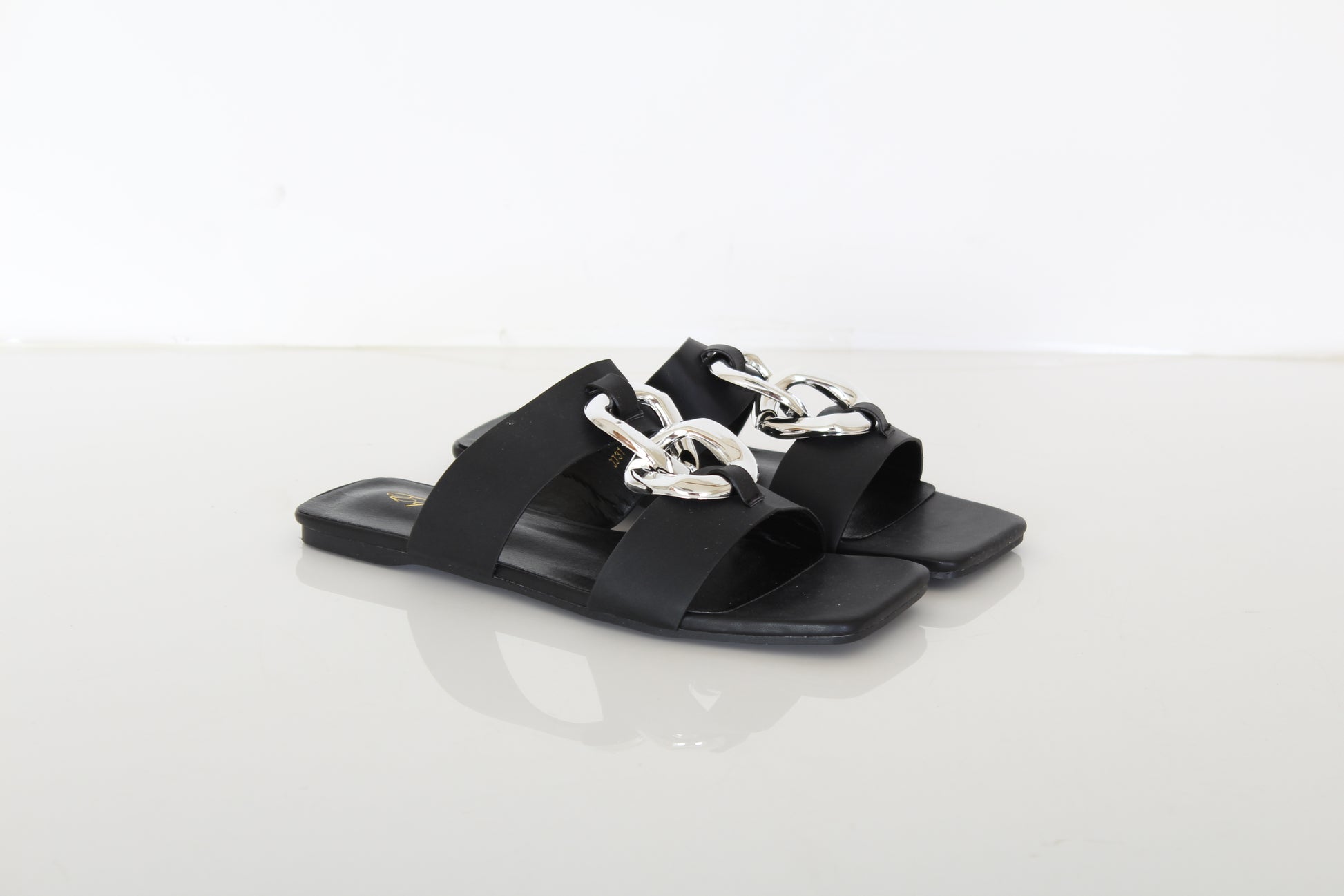 black slippers with decorative chain on top